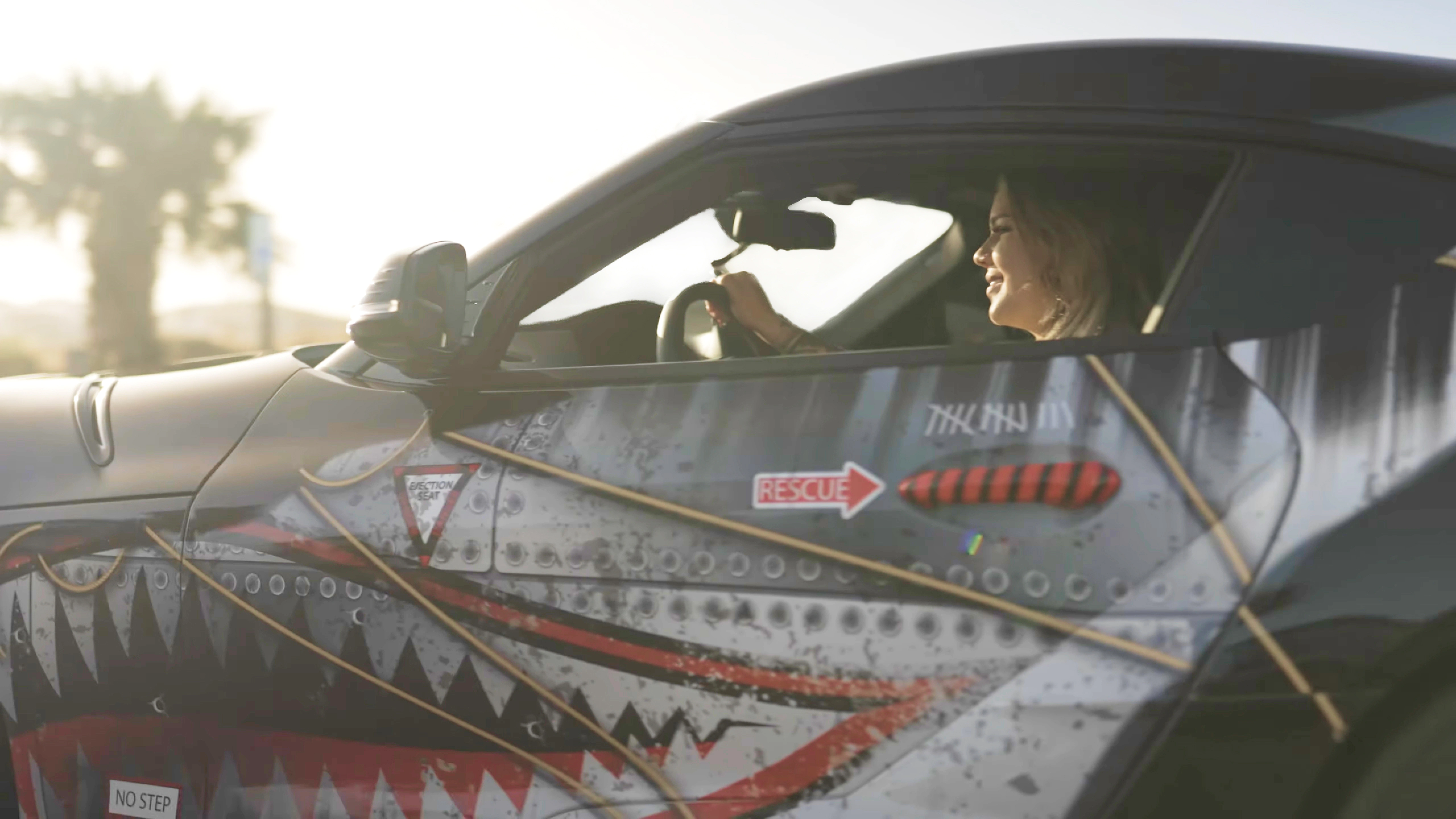 A lady driving a wrapped car desktop